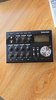 Full view of Tascam DP-004 showing control knobs, buttons, and display screen on top surface.
