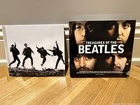 Front cover of the coffee table book 'Treasures of The Beatles' featuring color portraits of the band members.
