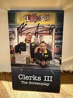 Front cover of Clerks III The Screenplay book with signature by Kevin Smith