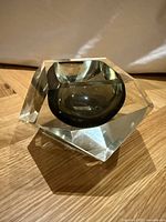 Side angled view showing the faceted clear glass with inner dark bowl