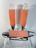 Two table lamps and one hanging pendant shown from above on clear table surface