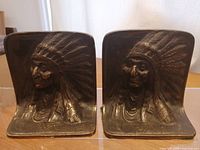 Pair of antique cast Native American Indian chief head bookends shown side by side.