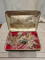 Open presentation case showing numerous cuff links individually bagged inside