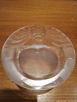 Top view of the round glass ashtray showing the frosted lion head design.