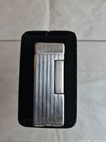 Front view showing vertical fluted front panel on black display pad