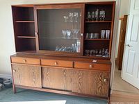 Full front view of buffet and hutch with glassware displayed