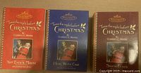 Three Hallmark Keepsake ornament boxes closed, showing front cover artwork and titles of the Twas the Night Before Christmas series.