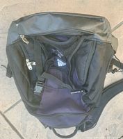 Top angled view of Adidas shoulder soccer bag showing multiple zippered compartments and mesh front pocket with Adidas logo.