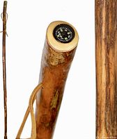 Full length of the rustic hardwood walking stick showing natural wood finish and leather strap.