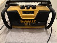Full front view of DeWalt construction radio with dual speakers and control panel.