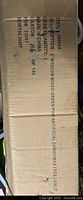 Box showing item description and details regarding the artificial tree, including dimensions and packaging information.