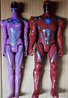 Two action figures side-by-side, Red and Pink Rangers from Power Rangers 2017 movie with armor detail visible.