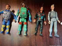 Photo of four Ghostbusters action figures including Winston Zeddmore, Ray Stantz in astronaut suit, Egon Spengler, and Peter Venkman.