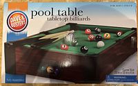 Box front showing Dave & Buster's tabletop pool table branding and game size dimensions.