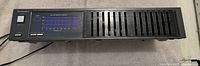 Front view of Technics stereo graphic equalizer showing power button, LED visual equalizer display, and 12 frequency band sliders.