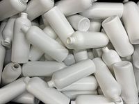 Multiple white tall 500ml cosmetic bottles piled together showing bottle shape and size.