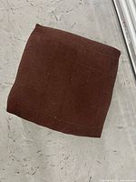 Top view of brown wool floor cushion showing grid stitching pattern