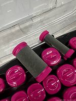 Close up of pink and black foam wrapped hot rollers