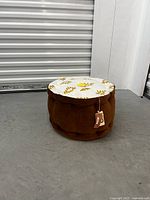 Angle showing the brown side and top with yellow pattern and pompom