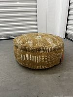 Side view showing the cushion's textured pattern and piping detail.