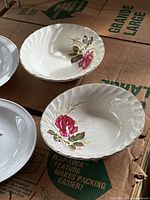 Two Ridgway Ironstone Anniversary Rose bowls showing red rose design with gold trim, scalloped edges, and embossed leaf texture on ceramic surface