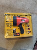 Front view of Vector Rescue Spotlight in original sealed yellow blister packaging showing product and features.