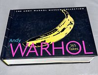 Front cover showing the title 'Andy Warhol 365 Takes' with a yellow banana graphic on a black background.