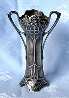 Front view of the silver plated Art Nouveau spill vase showing floral embossed pattern and handles.