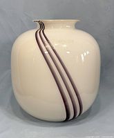 Front view of white bulbous vase with three purple stripes showing overall design and shape