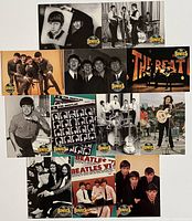 Photo showing all 12 Beatles collector cards arranged in a grid, each featuring different black-and-white or color band images and logo