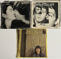 Front covers of three 45rpm vinyl records: John Lennon 'Just Like Starting Over', Paul McCartney 'Coming Up', and George Harrison 'All Those Years Ago'.