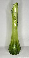 Front view of the tall green glass vase with detailed swung irregular top edge