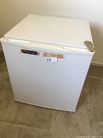 Closed view of the white cube fridge showing a compact cube shape with slightly rounded edges.