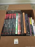Overhead view of box with spines showing Dungeons & Dragons and other RPG books and graphic novels