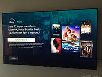 TV powered on displaying Disney+ Hulu screen