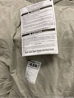 Top view of the air mattress surface with owner's manual and a tag showing model and size details.