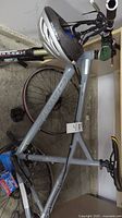 Side view of grey Giant Rainier bike lying on garage floor