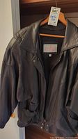 Front view of black leather zipper jacket by Pelle Original, size M, showing collar, zipper, and pockets