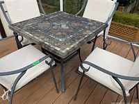 Overview of square table and four chairs on deck