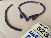 Both necklace and bracelet laid out flat, showing full length of each with lapis lazuli stones and silver settings visible.