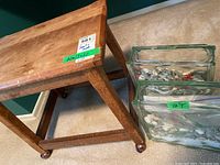 Wood stool on casters next to two glass containers with stones