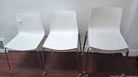 Three chairs side by side showing overall shape and finish