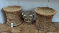 Two woven bamboo stools and one wicker wastebasket placed side by side on a tile floor, showing size and condition.