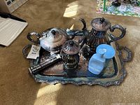 Full lot on carpet showing tray, two pitchers, sugar bowl, polish brush and soap bottle