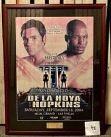 Framed boxing poster of Oscar De La Hoya vs Bernard Hopkins with ticket stub from September 18, 2004 event at MGM Grand in Las Vegas. Poster shows portrait of both fighters and event details.