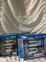 Photo showing two boxed Crest collectible toothbrush sets featuring Star Wars and Frozen themes with toothbrushes and toothpaste inside.