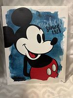 Front view of the Mickey Mouse canvas print showing the full character graphic and background text.
