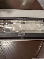 Salad server set in original black box with satin white lining and clear cover showing fork and spoon servers.