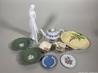 Full lot including Royal Doulton figurine, Herend pin dish, Wedgwood ashtrays, Carltonware dish, and additional porcelain plates and creamers