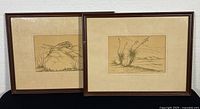Two framed pen and ink drawings side by side showing overall size and frame condition